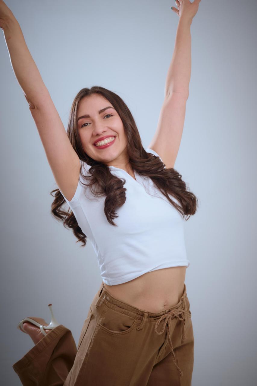 Julieth Castillo saltando con los brazos en alto, llena de alegría